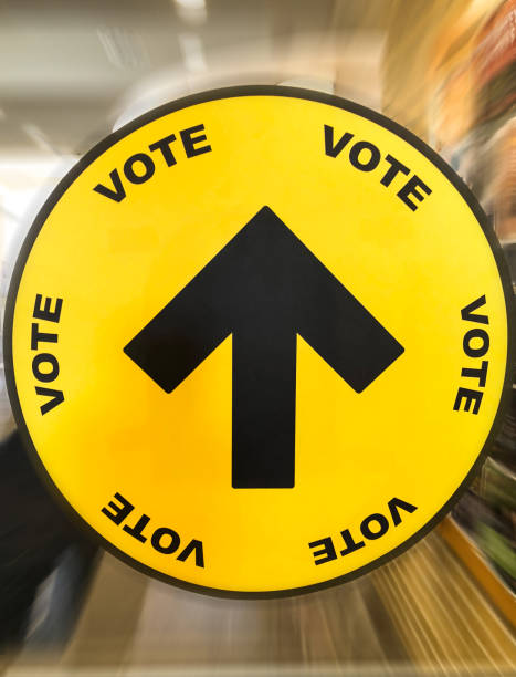 istock Round Vote directional sign with arrow pointing straight ahead 1454278319
