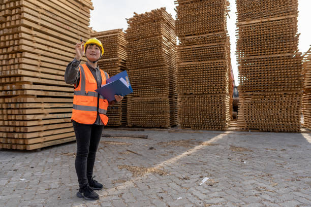 istock A female warehouse worker works in an open-air timber warehouse 1454279153