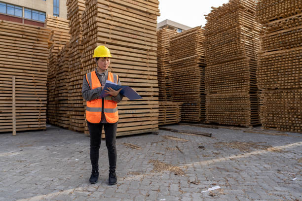 istock A female warehouse worker works in an open-air timber warehouse 1454279178