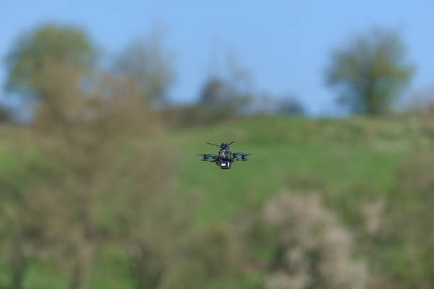 istock Very small and tiny toothpick class drone flies away from the camera 1454279956