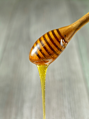 Honey pouring from honey dipper