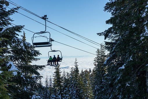 Vancouver, Canada - December 16, 2022: View of Screaming eagle chairlift with people at the Grouse mountain Ski Resort