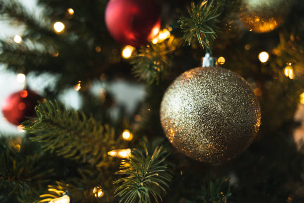 istock Christmas Scene. A Christmas tree ornament is hanging on the tree. Copy space. Christmas background. 1454287109