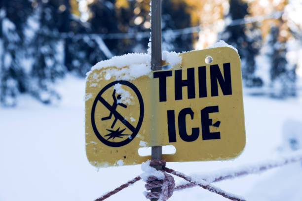 View of warning sign Thin Ice at the Blue Grouse Lake in British Columbia stock photo