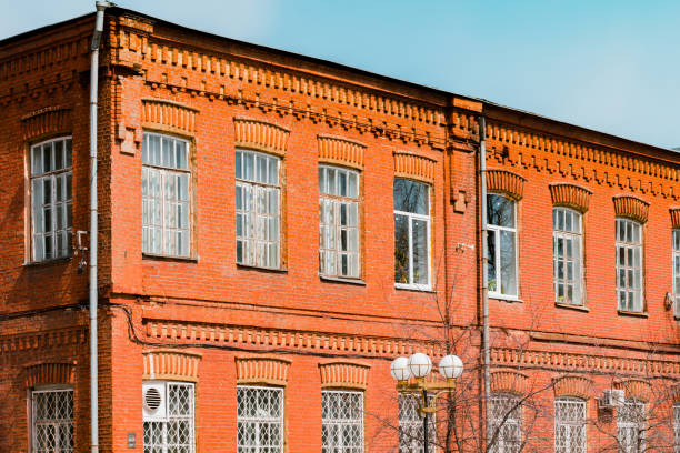 istock Old brick wall industrial factory building corner in sunlight blue sky. Architect. Architecture. History. Heritage. Design. Grunge urban. Industrial style. Red brick wall 1454287394