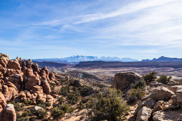 istock Rock formations with distant snow-covered mountains in the distance 1454287427