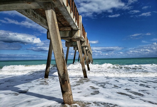 Vero beach, Florida pier on a beautiful sunny day with the waves breaking.