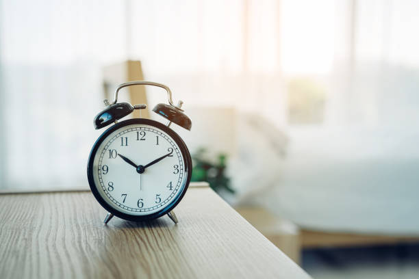 istock Closeup alarm clock having a good day with background. 1454294294