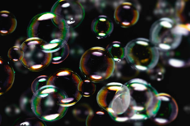 Abstract Beautiful Blurred Colorful Transparent Soap Bubbles on Black Background. Soap Suds Bubbles Water.