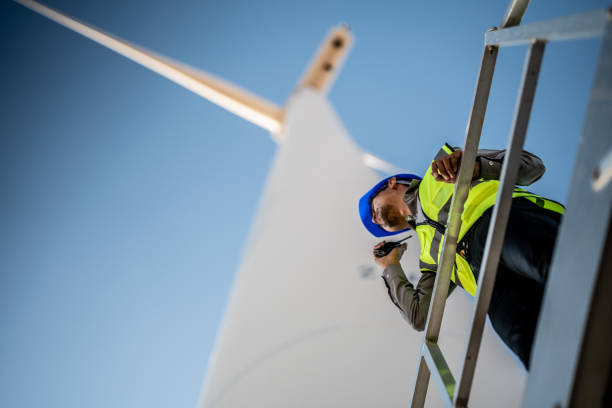 istock Asian engineer working in fieldwork outdoor. Workers check and inspect construction and machine around building project site. Wind turbine for electrical of clean energy and environment sustainable. 1454295919