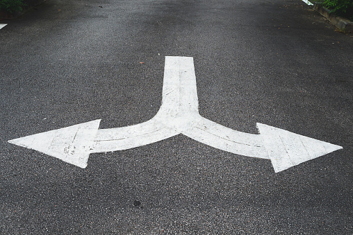 White arrow symbols pointing left and right give directions on the road.