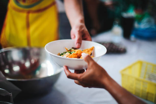 istock Feeding the poor to hands of a beggar, Poverty concept 1454296845