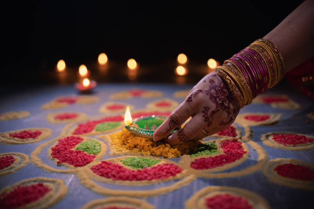 istock Happy Diwali - Diya lamps lit during diwali celebration 1454299501