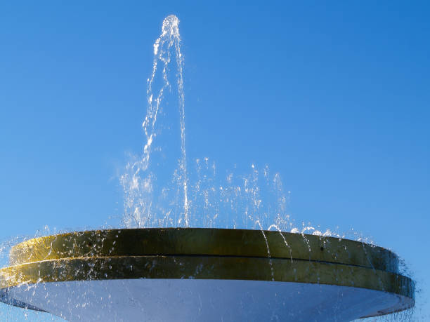 istock Water sprays skyward from circular fountain 1454299579