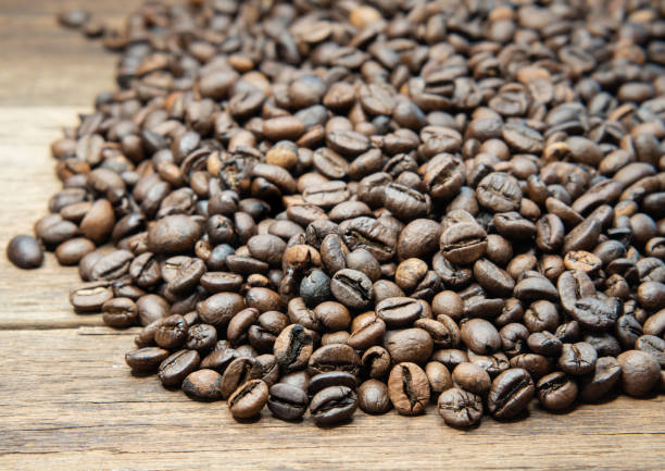 istock Roasted coffee beans arranged on a wooden floor. 1454301116