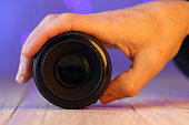 chinese 50mm lens in hand on table