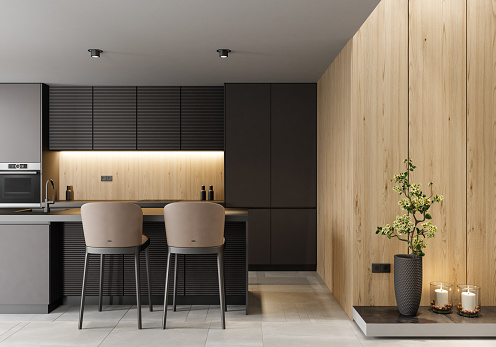 Modern black kitchen on one wall with dark long island with stools.