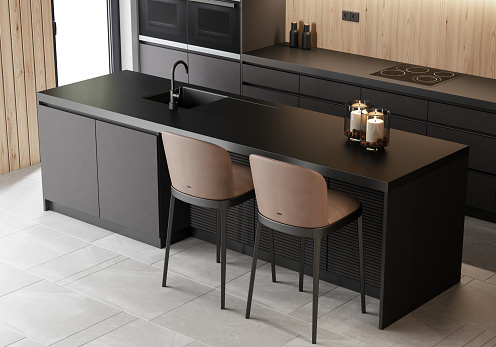 Modern black kitchen on one wall with dark long island with stools.