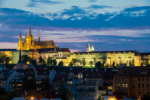 Aerial panorama night view of Český Krumlov old town with the Cesky Krumlov castle and tower in background and Vltava river flowing around, Czech Republic