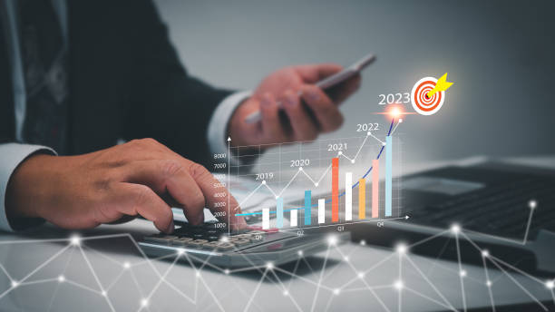istock Businessmen using calculators, analyzing virtual digital graphics.Profit forecasting company business growth in 2023 Calculate financial data for investment and development of professional planning. 1454309726