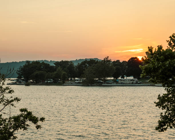 istock Calm lake surrounded by trees during a scenic sunset 1454311029