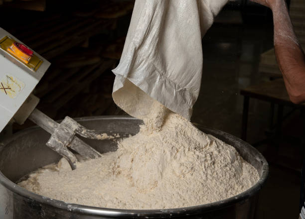 istock Loading flour into an industrial dough mixer for bakery products. 1454311676