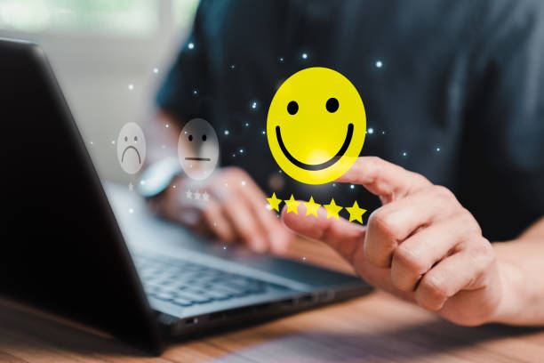 istock Man hand using computer laptop with popup five star icon for feedback review satisfaction service, testimonial. Customer service experience and business satisfaction survey. 1454312722