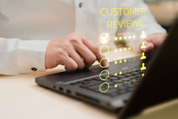 istock Man hand using computer laptop with popup five star icon for feedback review satisfaction service, testimonial. Customer service experience and business satisfaction survey. 1454314384