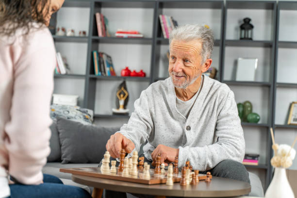 istock Dementia therapy in playful way.  senior elder man stay at nursing home, enjoy activity relation playing chess 1454314669