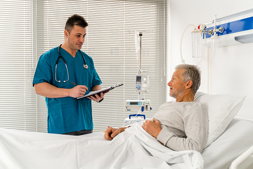 Doctor talking to patient  at the hospital