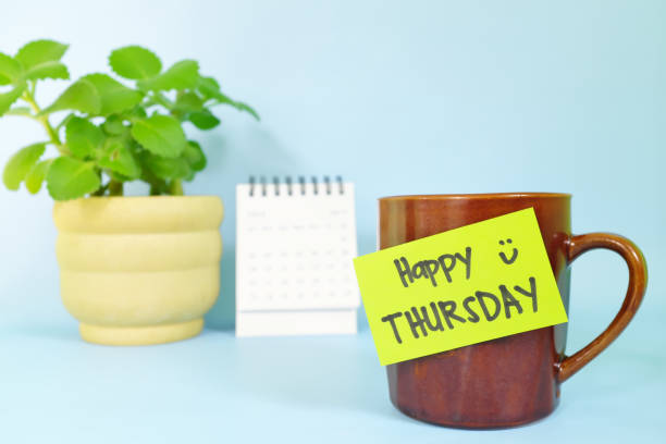 istock Welcome, hello and happy Thursday concept. Selective focus of coffee cup with green paper note and written message. 1454318632