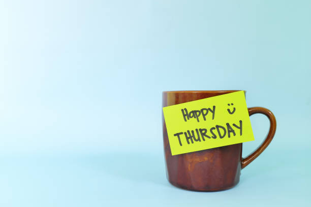 istock Welcome, hello and happy Thursday concept. Selective focus of coffee cup with green paper note and written message. 1454318636