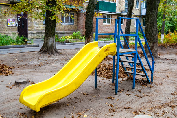 Photography on theme empty playground with metal slide for kids on background natural nature, photo consisting from playground with steel slide, slide on old playground in urban area without people