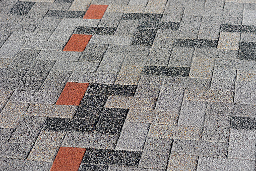 Granite cobblestoned pavement background. Stone pavement texture. Abstract background of cobblestone pavement close-up. Seamless texture.
