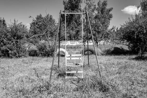 Photography on theme empty playground with metal swing for kids on background natural nature, photo consisting from playground with steel swing, swing on old playground in countryside without people