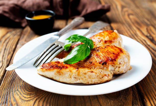 istock Marinated grilled healthy chicken breasts cooked on a summer BBQ and served with fresh herbs and lemon juice 1454324033