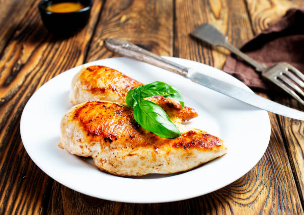 istock Marinated grilled healthy chicken breasts cooked on a summer BBQ and served with fresh herbs and lemon juice 1454324040