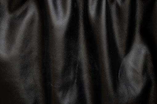 background of black pleated faux fabric