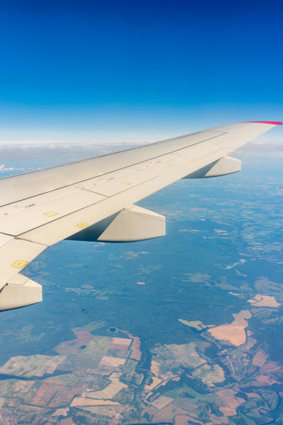 istock View from the airplane window at a beautiful cloudy sky and the airplane wing 1454327737