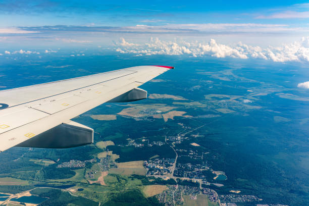 istock View from the airplane window at a beautiful cloudy sky and the airplane wing 1454327782