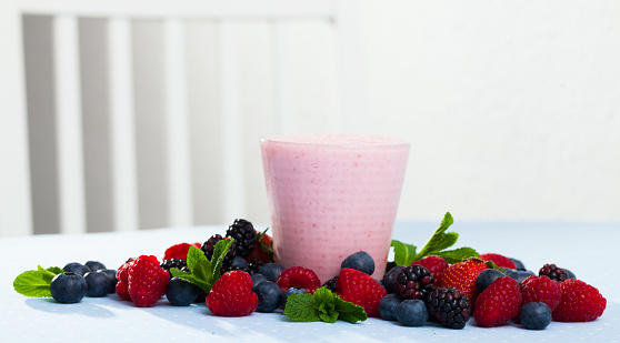 Delicious yogurt smoothie with diversity fresh berries and mint for healthy breakfast