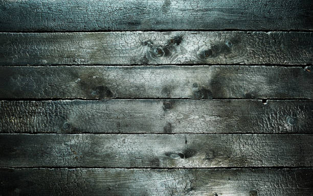 istock Dark textured wooden background with black burnt surface for barbeque 1454330502
