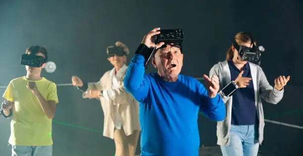 Photo of Elderly parents use virtual reality glasses with children