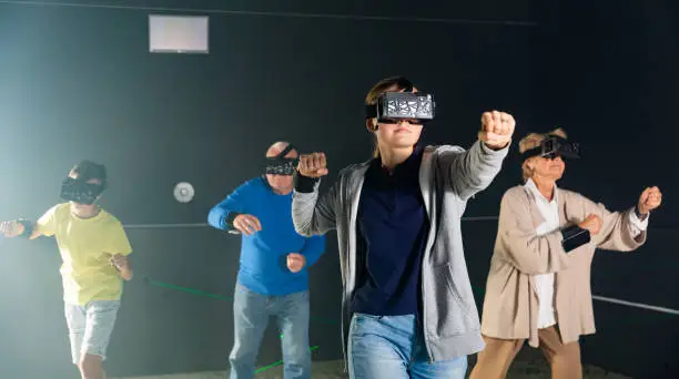 Photo of Teenage girl using virtual reality glasses with family