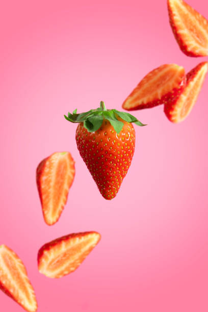 istock Closeup of strawberries on a pink background 1454332896
