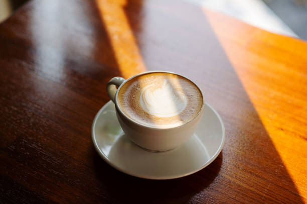istock hot latte art coffee on wood table, relax time 1454333682
