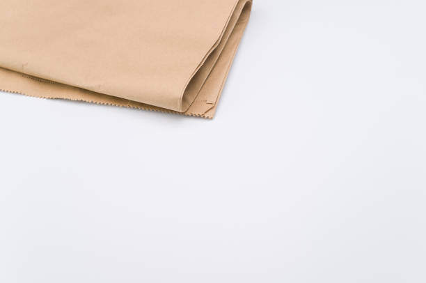 istock recycled brown Kraft paper folded on white background 1454333747