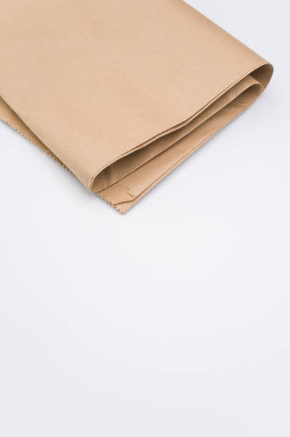 istock recycled brown Kraft paper folded on white background 1454333766