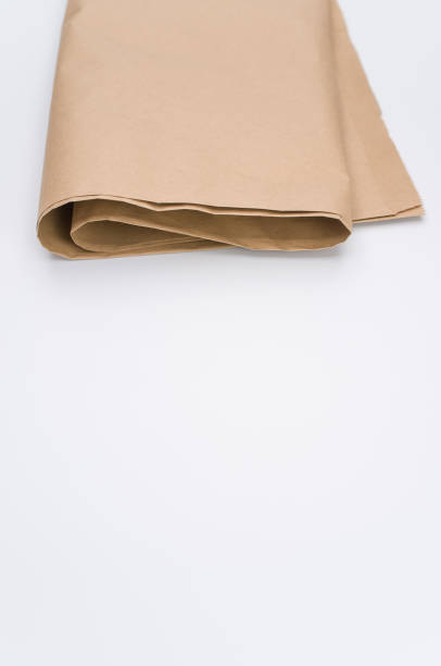 istock recycled brown Kraft paper folded on white background 1454333776