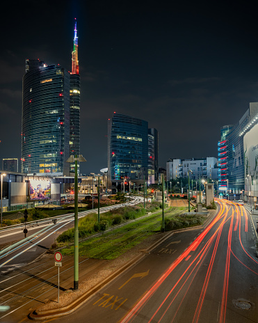 Milano, Italy – January 29, 2021: A long exposure of the street and skyscrapers of Piazza Gae Aulenti in Milan, Italy